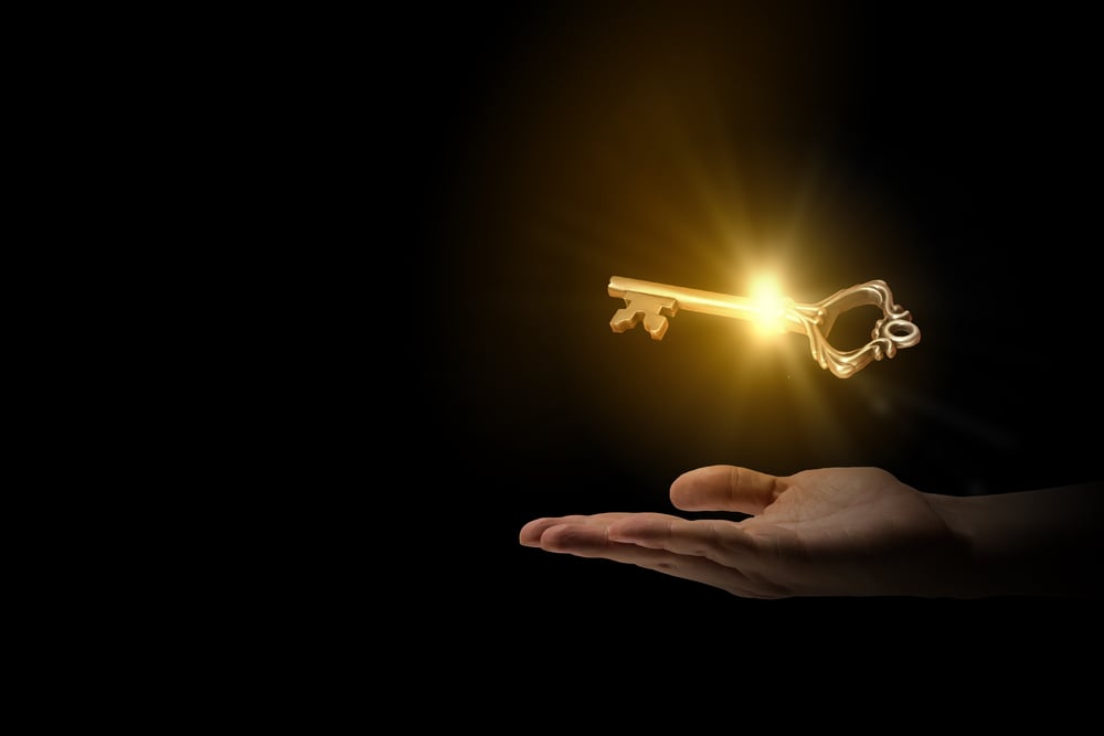 Close up of human hand holding golden key-3