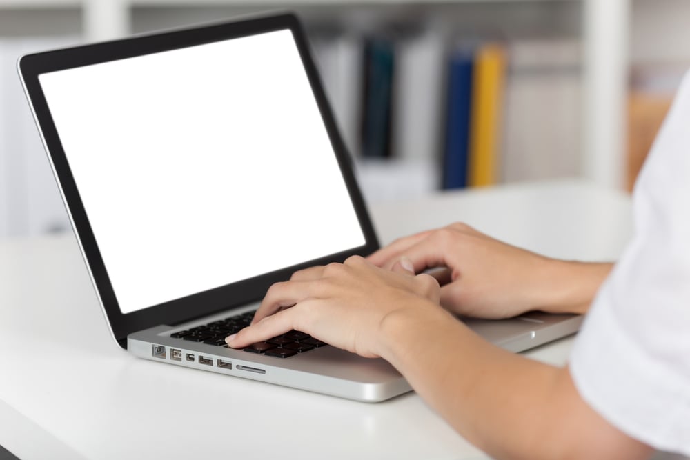 Rear view of business woman hands busy using laptop at office desk, with copyspace-1
